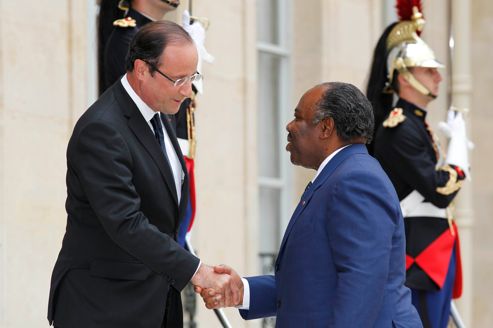 France's President Hollande shakes hands with Gabon's President Bongo Ondimba as he arrives for a meeting at the Elysee Palace in Paris